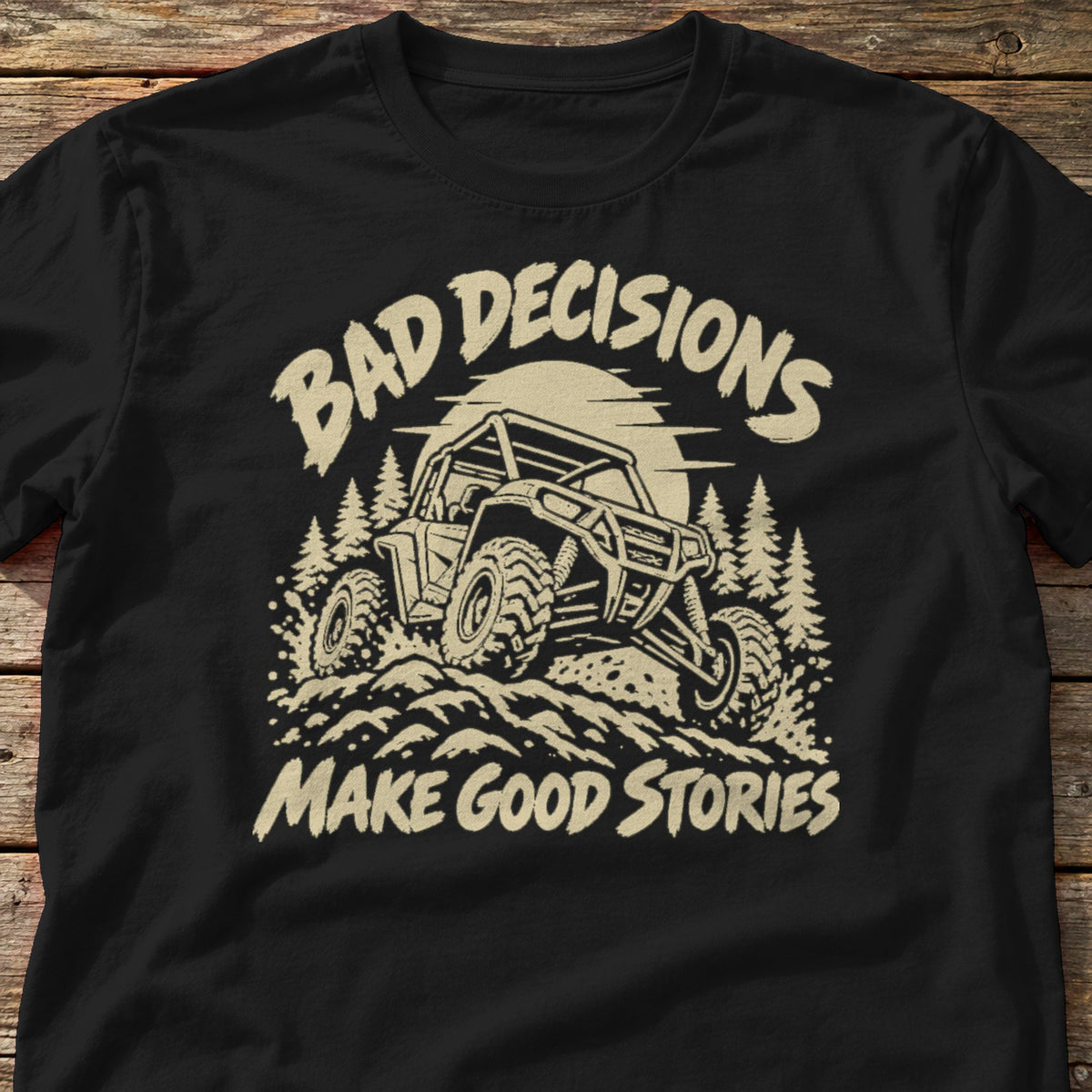 Bad Decisions Make Good Stories t-shirt in Black, laid flat on weathered wood
