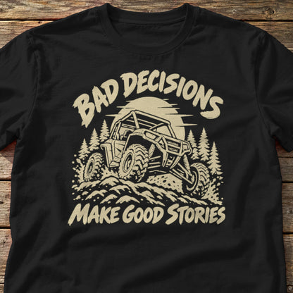 Bad Decisions Make Good Stories t-shirt in Black, laid flat on weathered wood