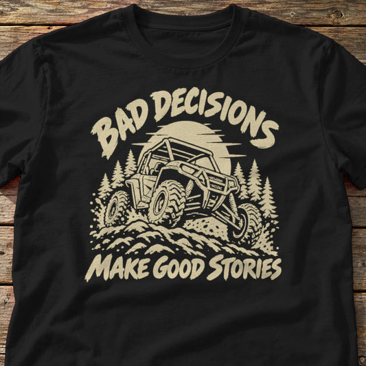 Bad Decisions Make Good Stories t-shirt in Black, laid flat on weathered wood