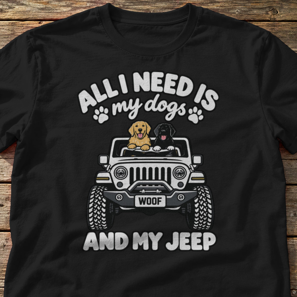 All I Need Is My Dogs and My 4x4 t-shirt in Black, laid flat on weathered wood