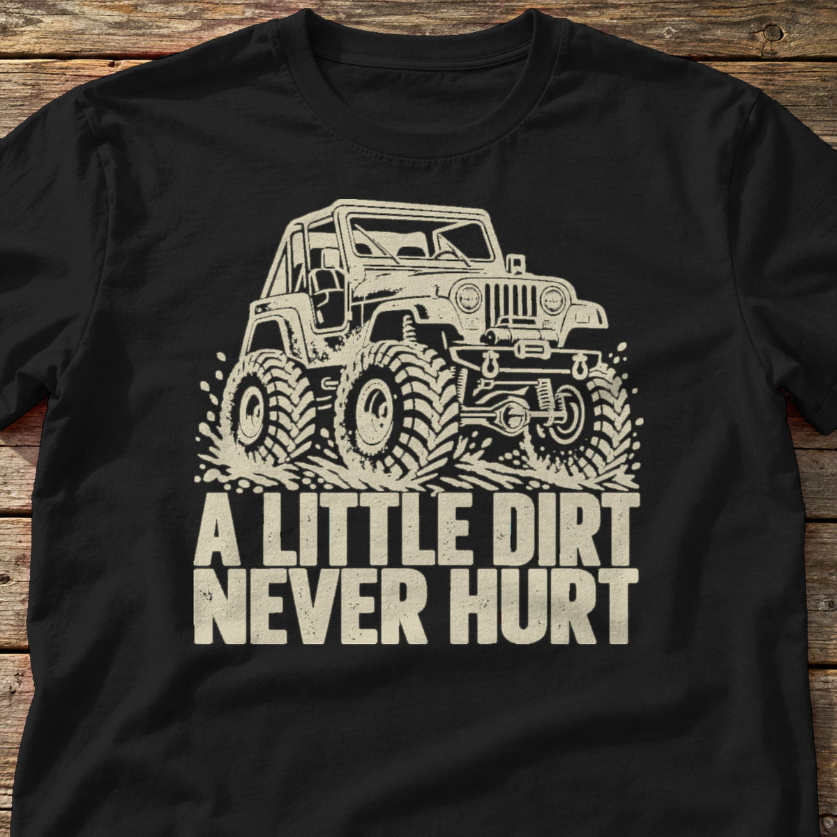 A Little Dirt Never Hurt t-shirt in Black, laid flat on weathered wood