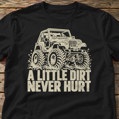 A Little Dirt Never Hurt t-shirt in Black, laid flat on weathered wood