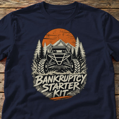 Bankruptcy Starter Kit t-shirt in Navy, laid flat on weathered wood