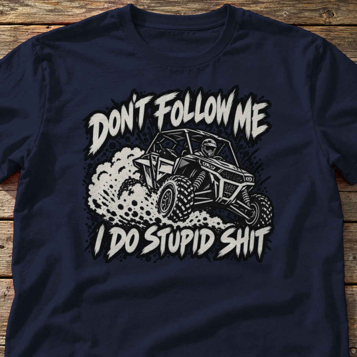 Don't Follow Me I Do Stupid Shit t-shirt in Navy, laid flat on weathered wood