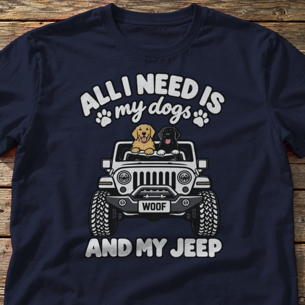 All I Need Is My Dogs and My 4x4 t-shirt in Navy, laid flat on weathered wood