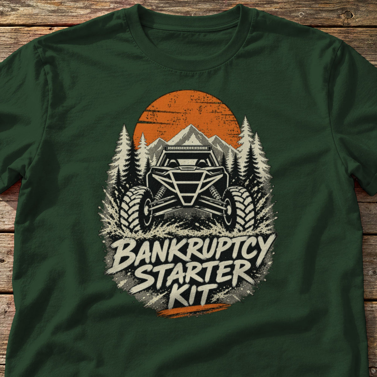 Bankruptcy Starter Kit t-shirt in Forest Green, laid flat on weathered wood
