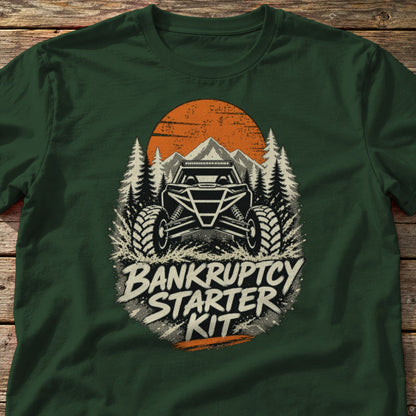 Bankruptcy Starter Kit t-shirt in Forest Green, laid flat on weathered wood