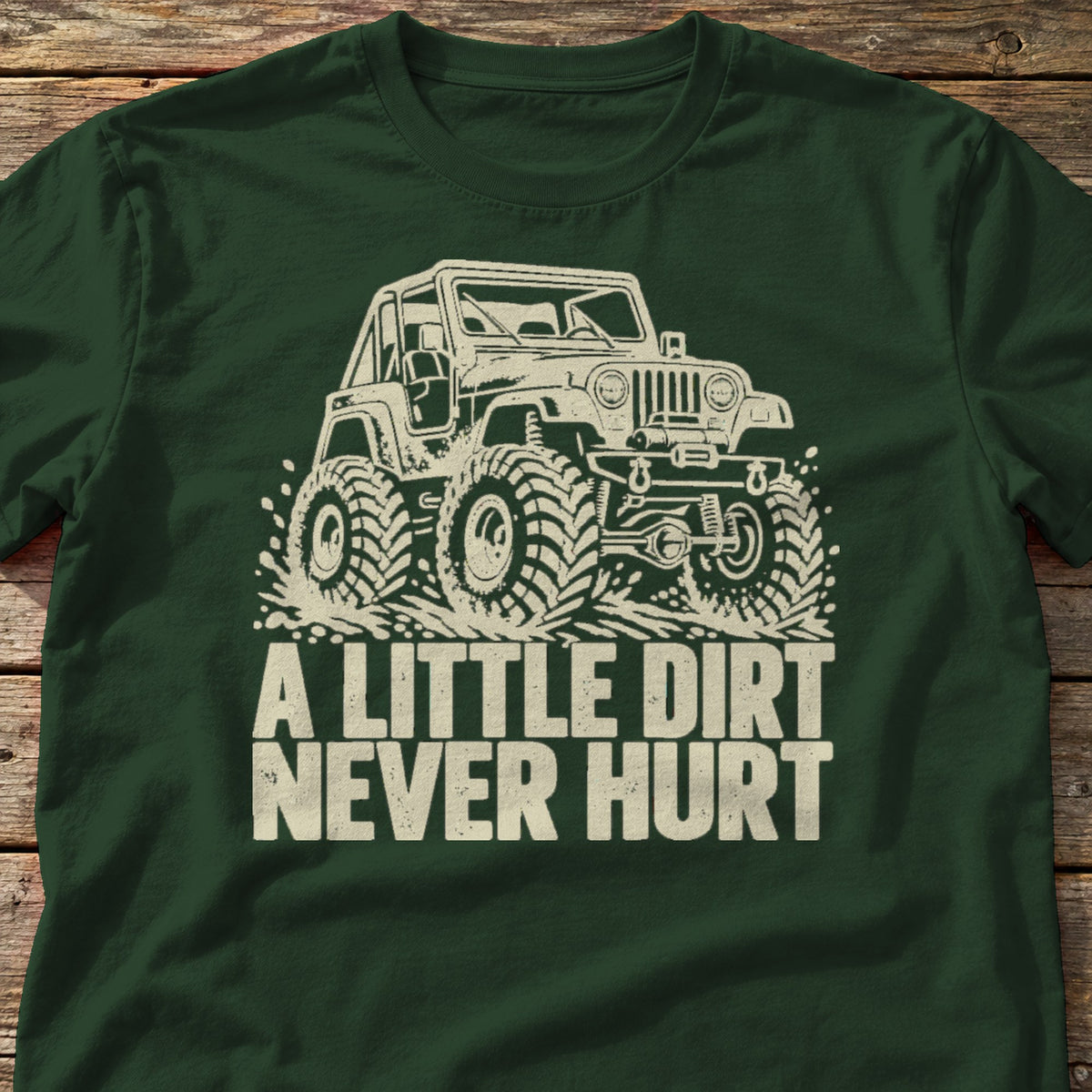 A Little Dirt Never Hurt t-shirt in Forest Green, laid flat on weathered wood