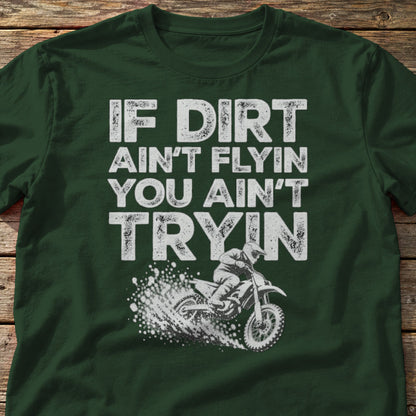 If Dirt Ain't Flyin You Ain't Tryin t-shirt in Forest Green, laid flat on weathered wood