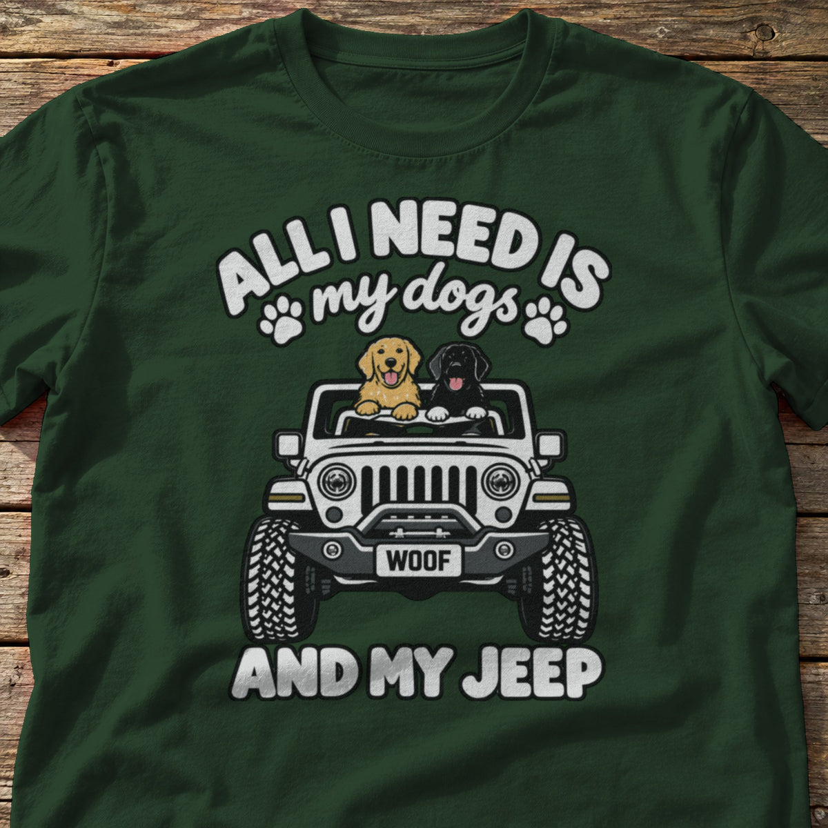 All I Need Is My Dogs and My 4x4 t-shirt in Forest Green, laid flat on weathered wood