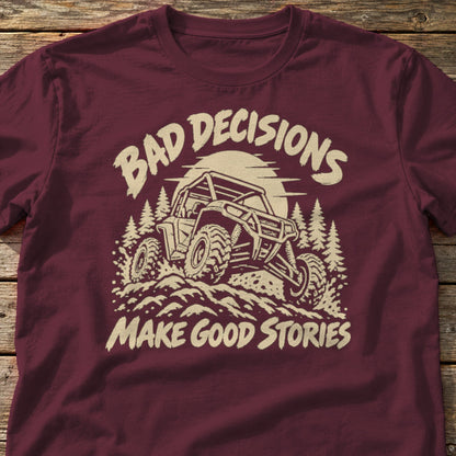 Bad Decisions Make Good Stories t-shirt in Maroon, laid flat on weathered wood