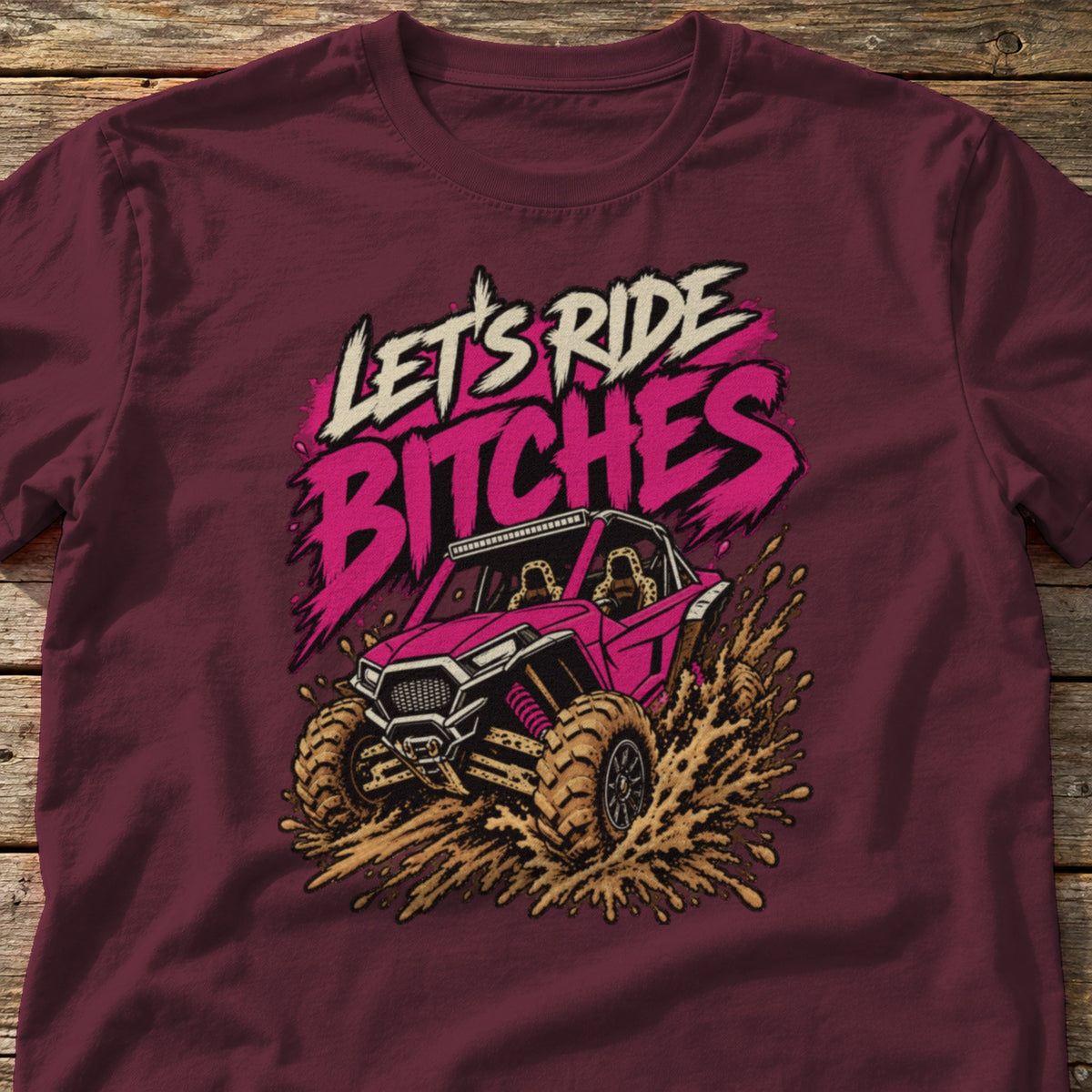 Let's Ride Bitches t-shirt in Maroon, laid flat on weathered wood