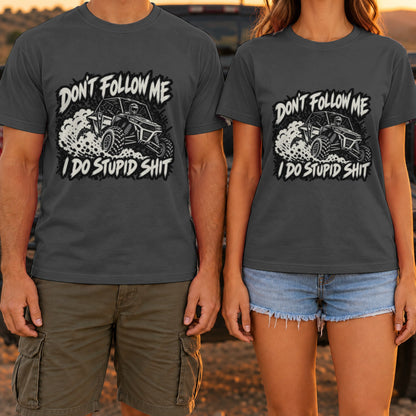 Don't Follow Me I Do Stupid Shit t-shirt in Dark Heather, worn by a couple at a truck tailgate